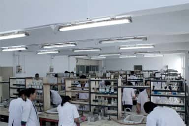 Medical students in white coats working at benches in a practical laboratory at Terna Medical College, Navi Mumbai