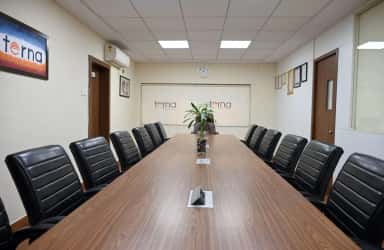 Long board-room style conference table with Terna branding on the wall at Terna Medical College, Navi Mumbai