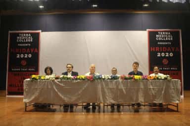 Dignitaries seated at a flower-decked dais under TERNA MEDICAL COLLEGE event banners on stage at Navi Mumbai