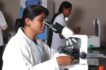 Students at microscopes in the microbiology laboratory, The Oxford Medical College