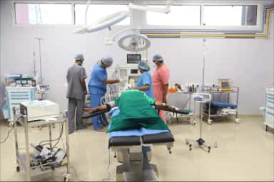 Operation theatre at VELS Hospital with surgical team and a draped patient