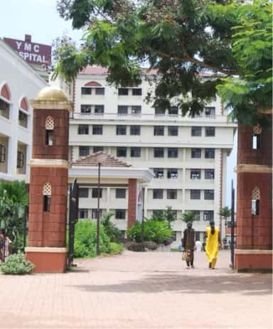 Entrance gate of Yenepoya Medical College Hospital at Deralakatte with the YMC Hospital building behind