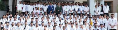 MBBS cohort of Zydus Medical College and Hospital in white coats in front of the main building at Dahod