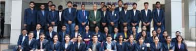 Zydus Medical College and Hospital students with senior faculty outside the main entrance at Dahod