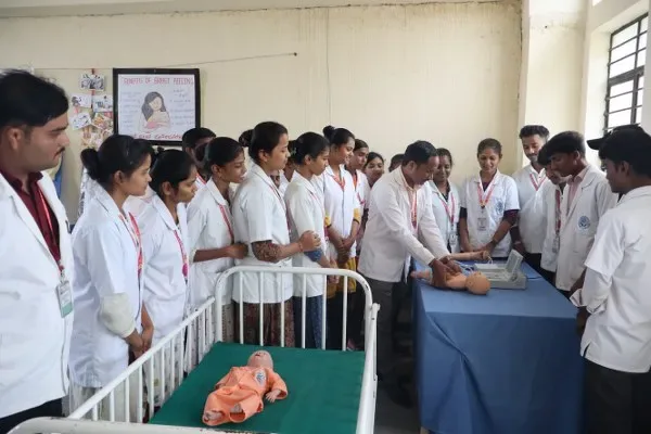 Students attend a child health nursing demonstration using infant mannequins — BLDEA's College of Nursing, Tikota