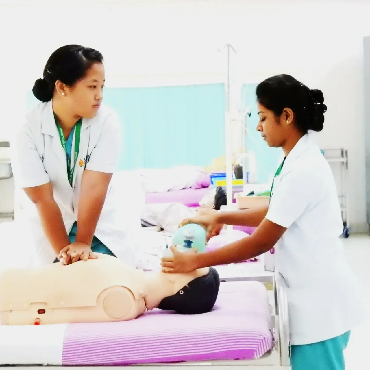 Nursing trainees practicing CPR and bag-mask ventilation on a mannequin — Saveetha College of Nursing