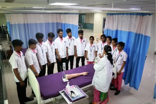 Students observing a clinical demonstration in the nursing skills lab — Bellary Institute of Nursing