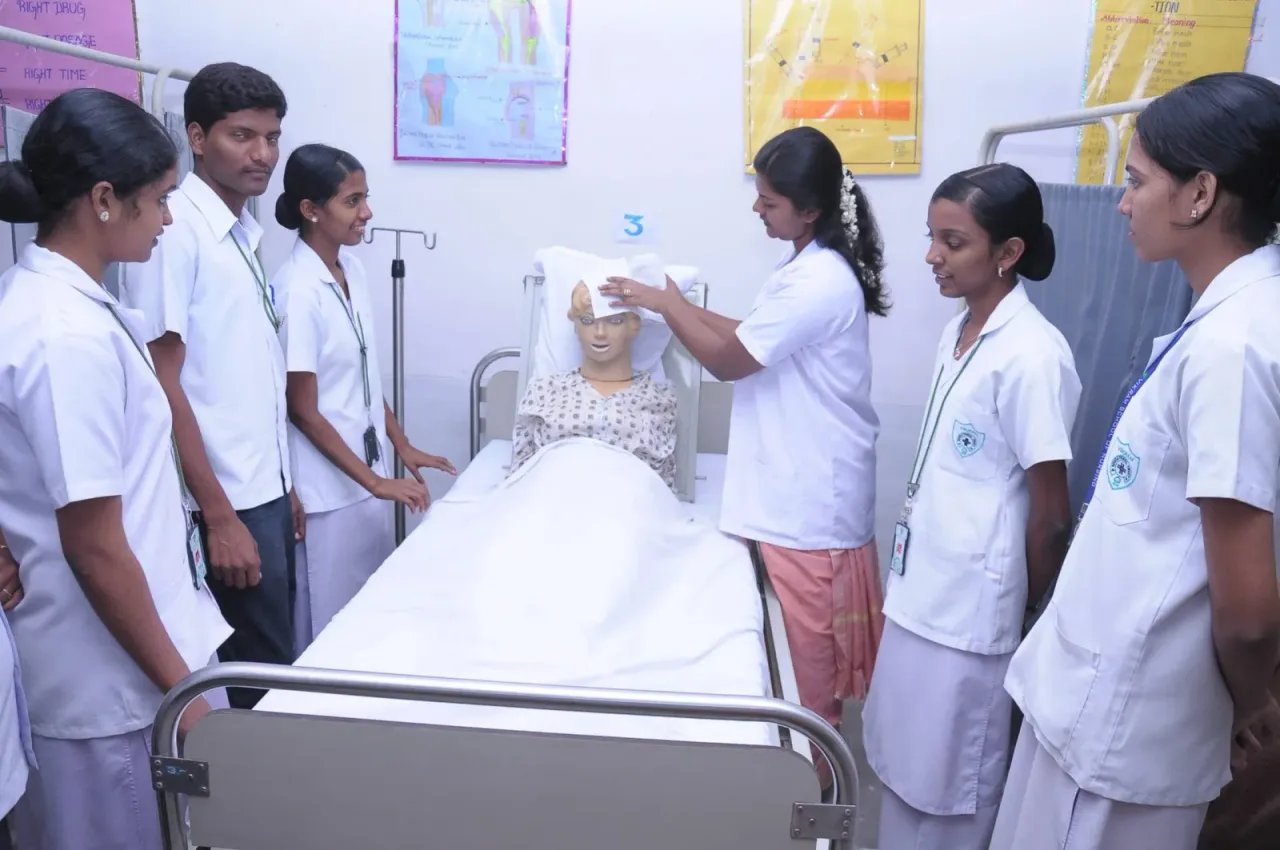 Nursing students practicing patient care with a training mannequin — Vikram College of Nursing (Vikram Institutions / Vikram Educational Trust)