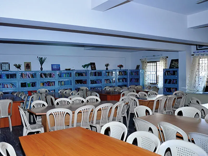 College library reading room with bookshelves and study tables — Manjushree School & College of Nursing