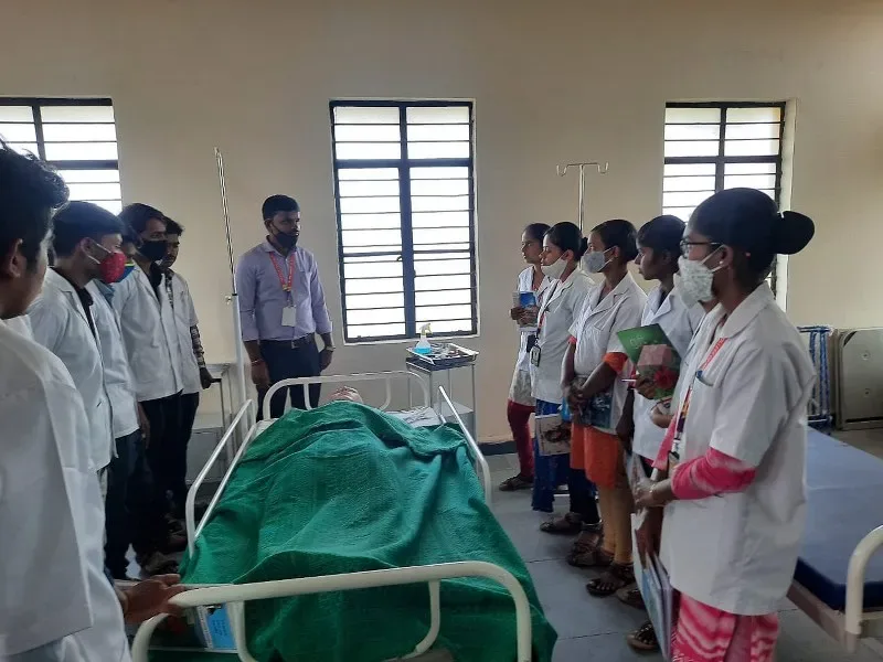 Nursing students observe an instructor beside a patient bed during clinical training — BLDEA's College of Nursing, Tikota