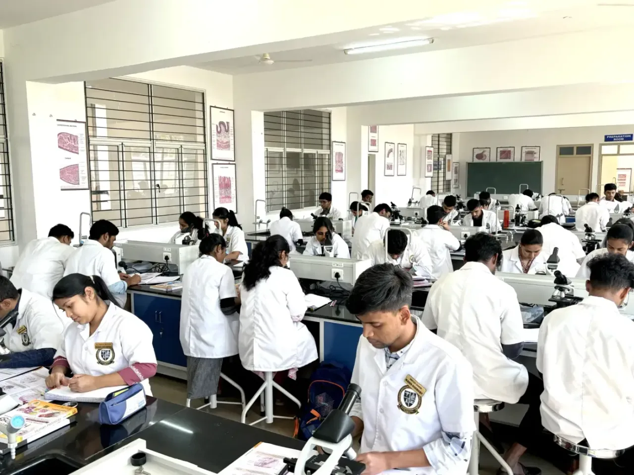 Students at microscopes during a practical in the histology laboratory of SSIMSRC