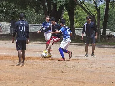 Students playing football on the sports ground of the SDUAHER campus at Tamaka, Kolar