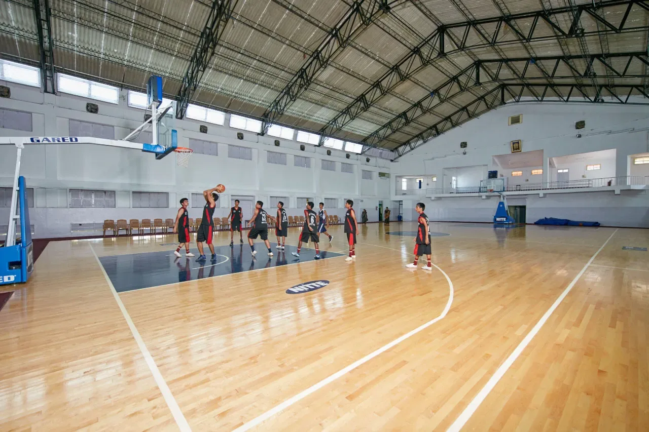 Students playing basketball in the NITTE indoor sports complex on the Deralakatte campus of K S Hegde Medical Academy