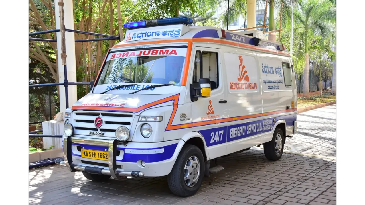 Siddaganga Hospital 24/7 emergency ambulance parked on the Tumakuru campus
