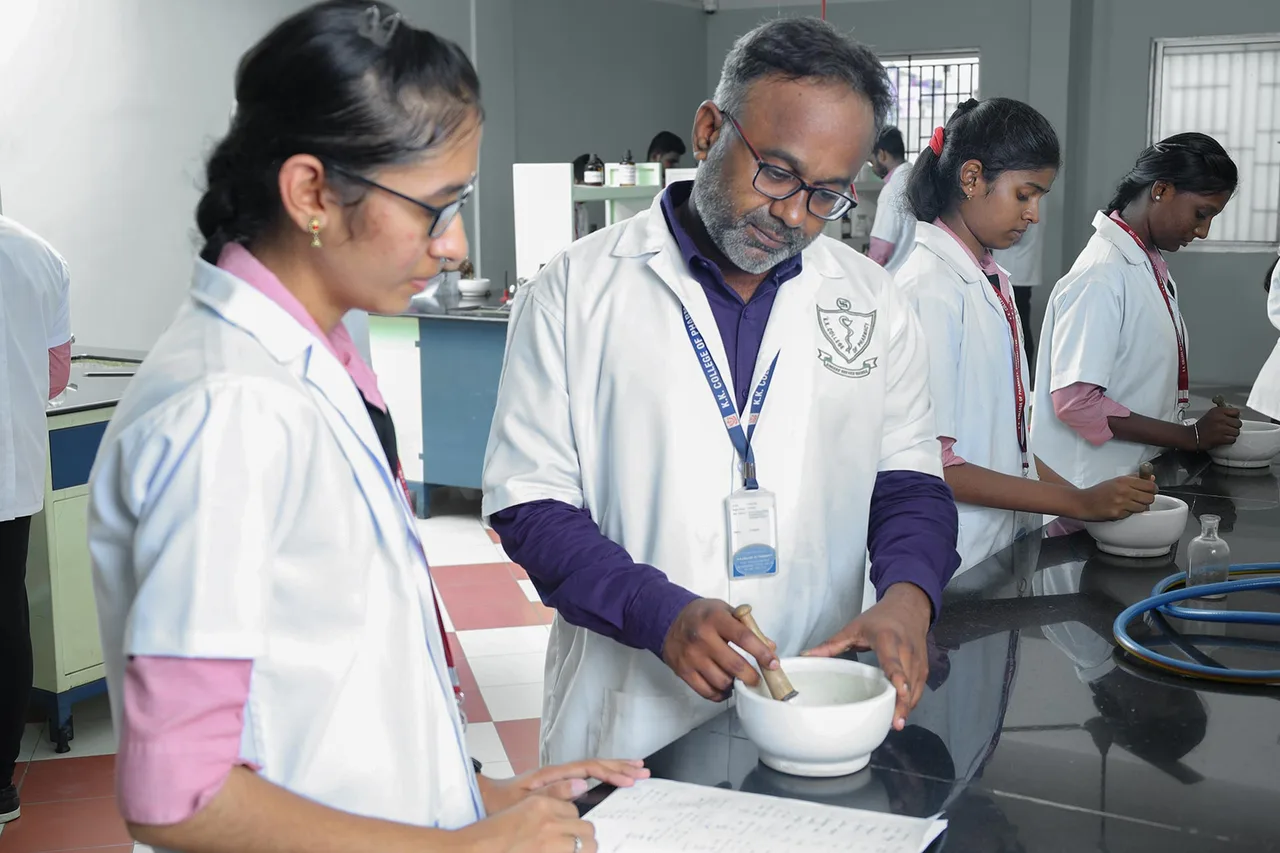 Teacher with Student at KK College of Pharmacy Lab — K.K. College of Pharmacy