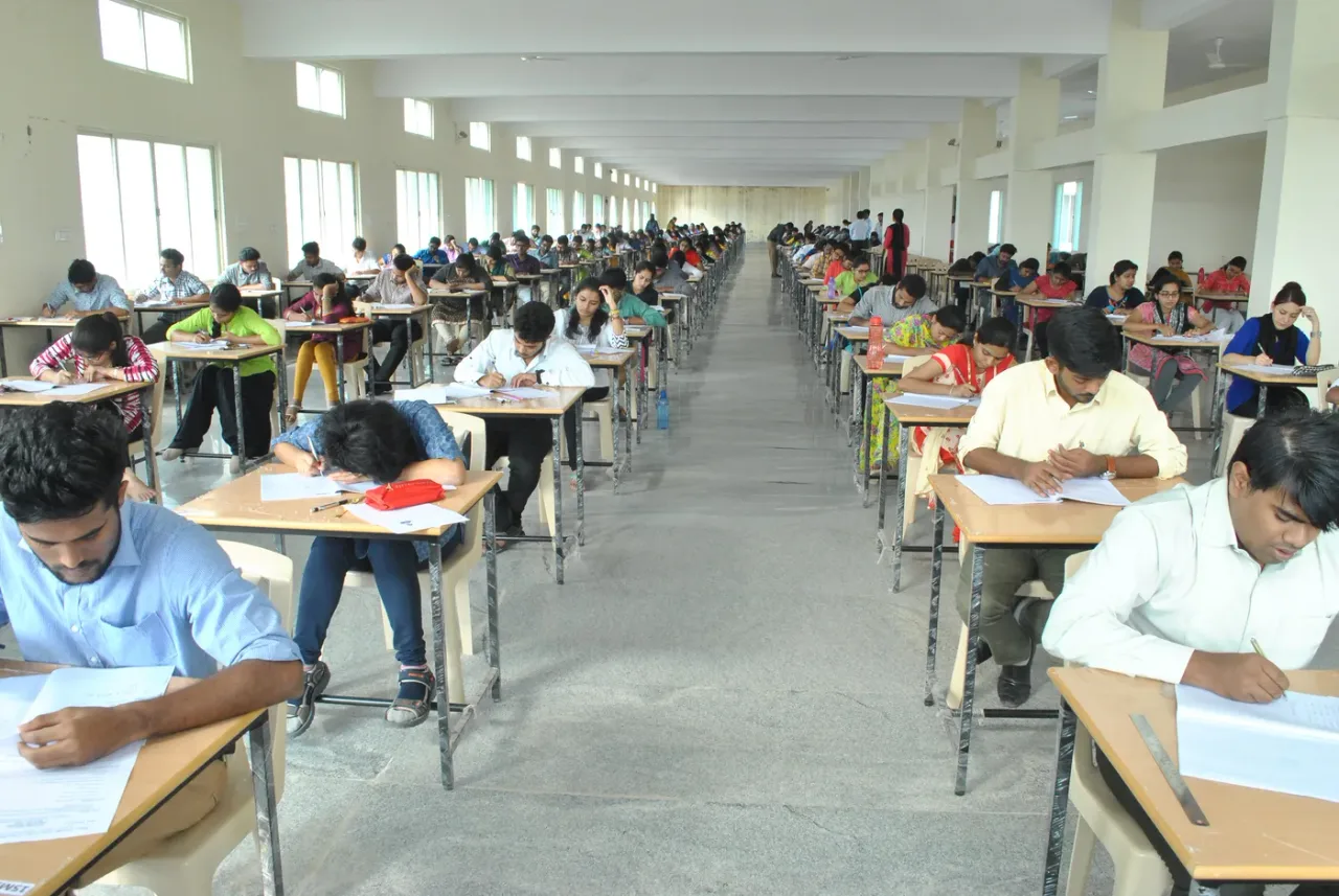 Students writing university examinations in the examination hall at Basaveswara Medical College, Chitradurga