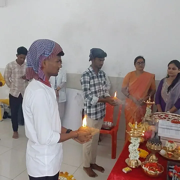 College group performing a ceremonial lamp lighting during Saraswati Puja — Agastya College of Nursing