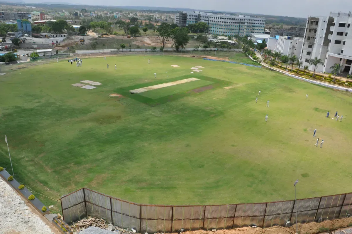 Aerial view of the cricket ground and campus blocks at RajaRajeswari Medical College, Bengaluru