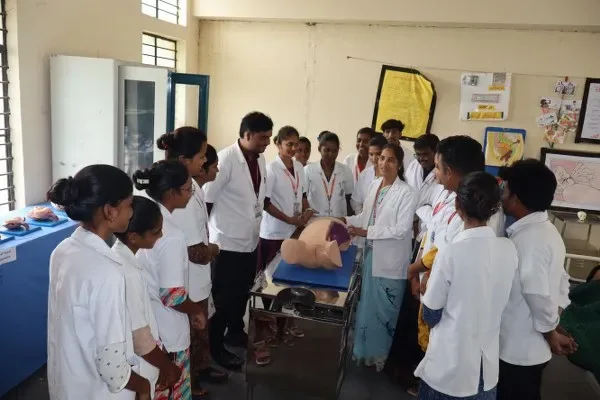 Students observe an obstetric mannequin demonstration in the midwifery lab — BLDEA's College of Nursing, Tikota