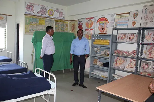 Clinical nursing skills lab with hospital beds and anatomical models — Kumuda School of Nursing