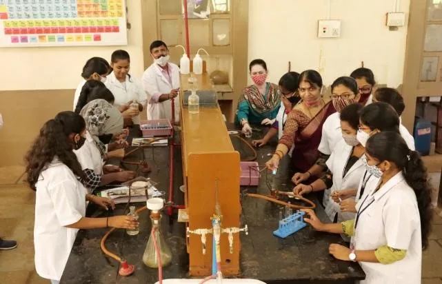 Students performing chemistry experiments in UG laboratory B. — Karnatak Science College, Dharwad