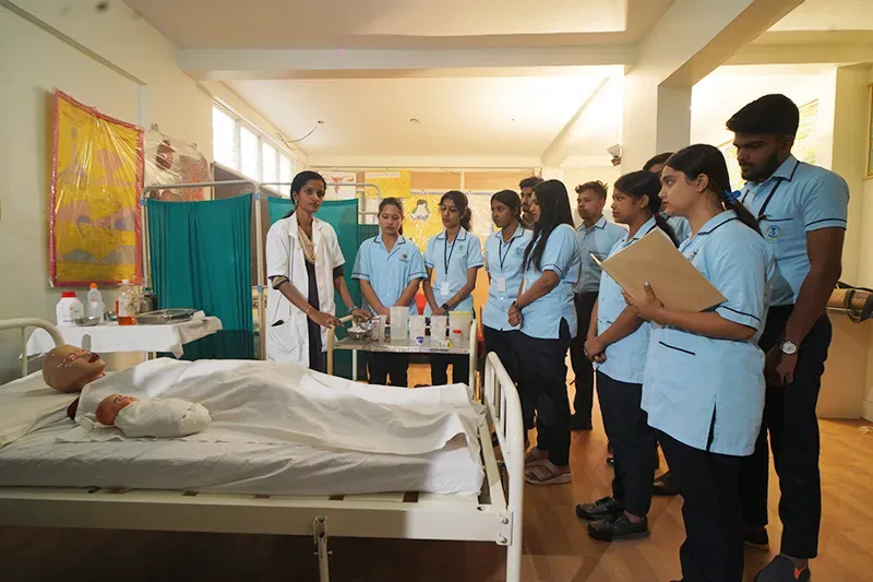 Students receiving bedside clinical training with a patient mannequin — Ananya School of Nursing
