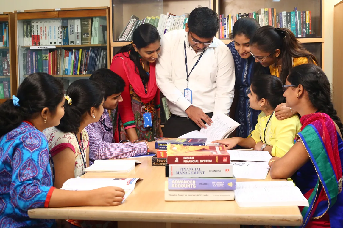Group discussion in library — Institute of Insurance and Risk Management