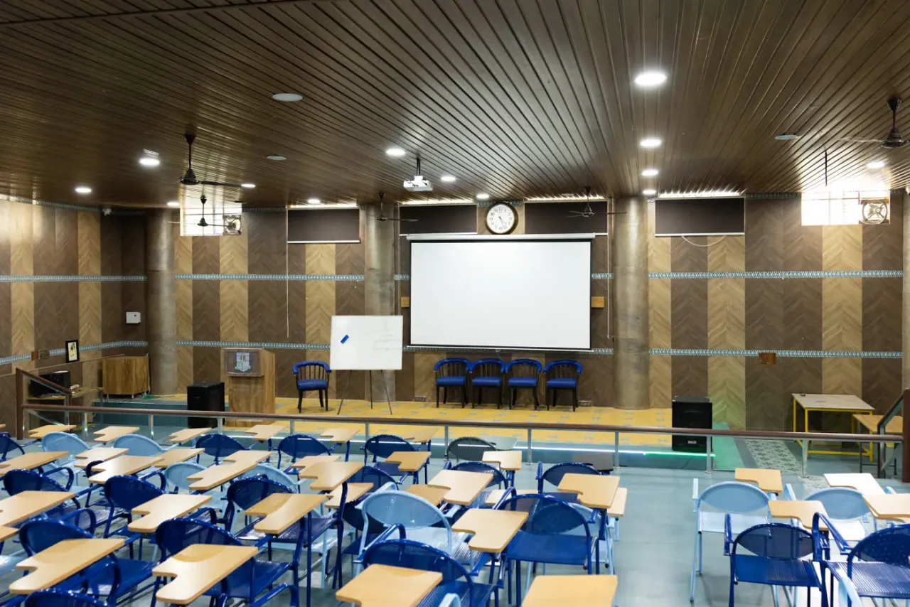 College auditorium with seating, stage, and projection facilities — AECS Maaruti College of Nursing