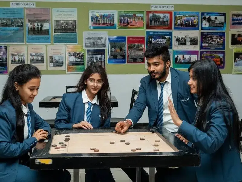 Student engagement at ABBS with indoor games like carrom. — Acharya Bangalore B-School