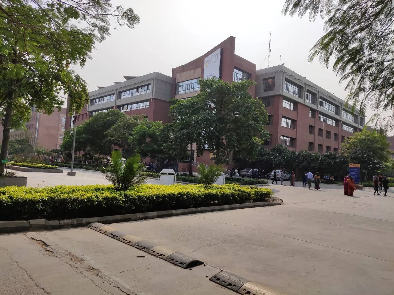 A view of Amity University's main building from the gate. — amity-education-group-noida