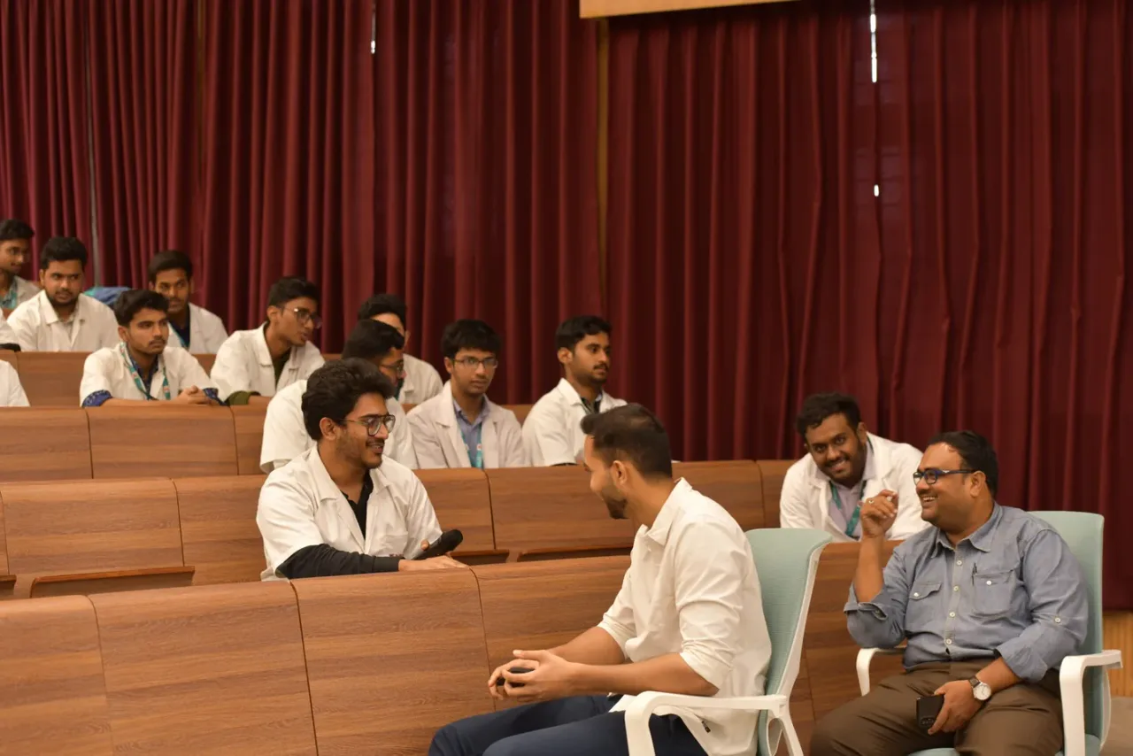 Students and faculty in a tiered lecture and seminar hall at Neelima Institute of Medical Sciences