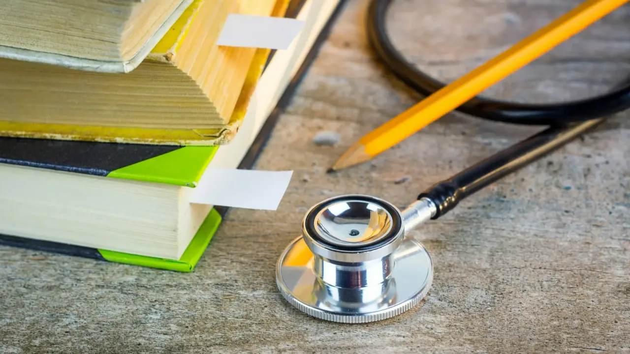 Medical study desk with stethoscope and notes — NEET UG 2026 counselling tracker