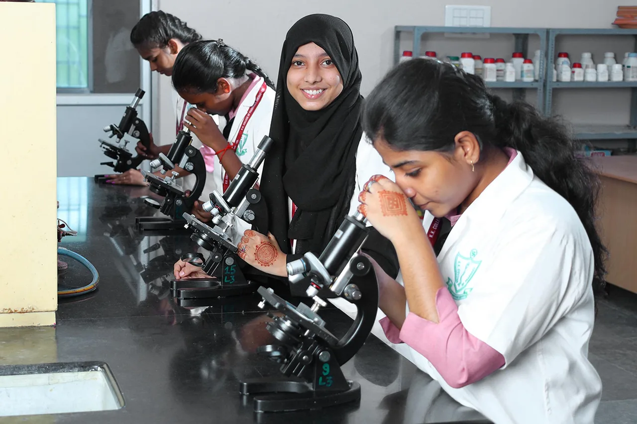 Students working with Microscope in Lab, KK College of Pharmacy — K.K. College of Pharmacy