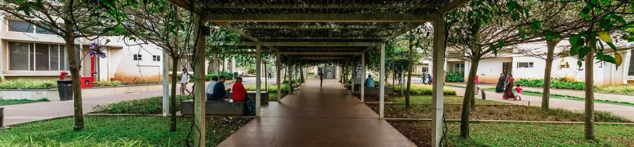 Tree-covered pergola walkway between buildings on the Nitte Deralakatte campus of K S Hegde Medical Academy