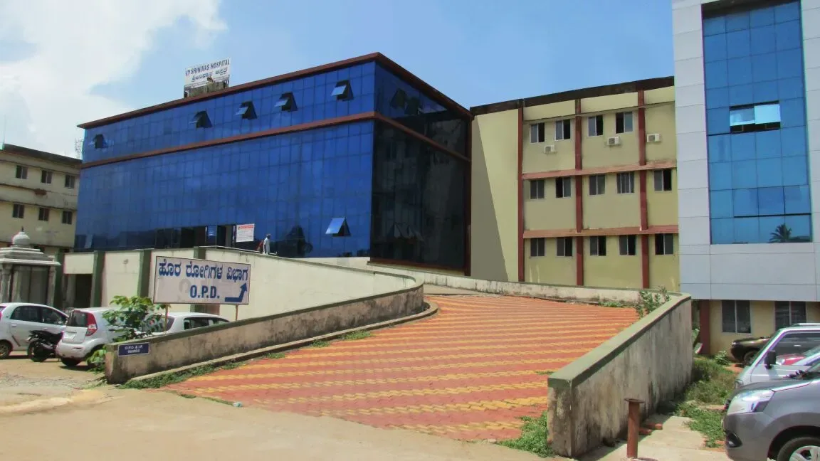 Srinivas Hospital building with outpatient department signage at Mukka, the teaching hospital of Srinivas Institute of Medical Sciences