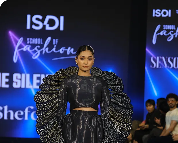 fashion design student showcasing outfit at runway show event — ISDI School of Design & Innovation