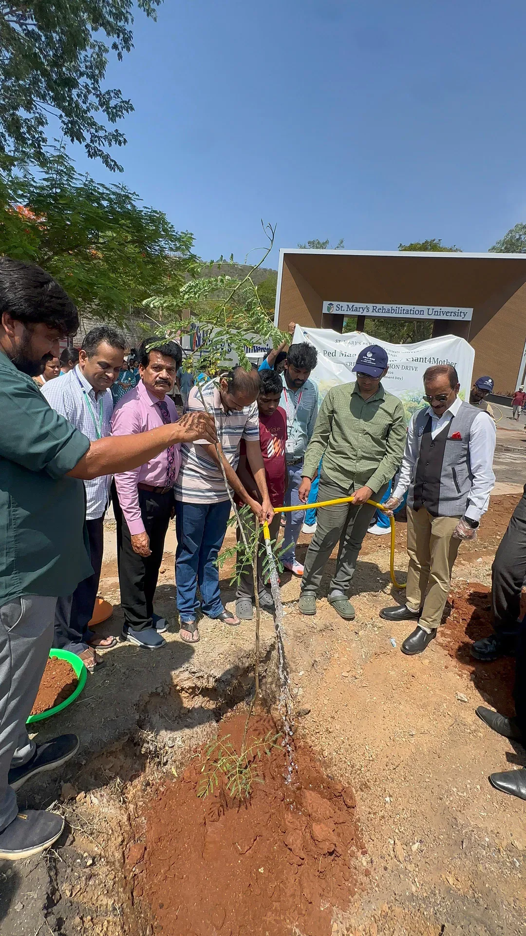 St.Mary's University Tree Plantation Drive participants watering a newly planted tree — St. Mary's Rehabilitation University