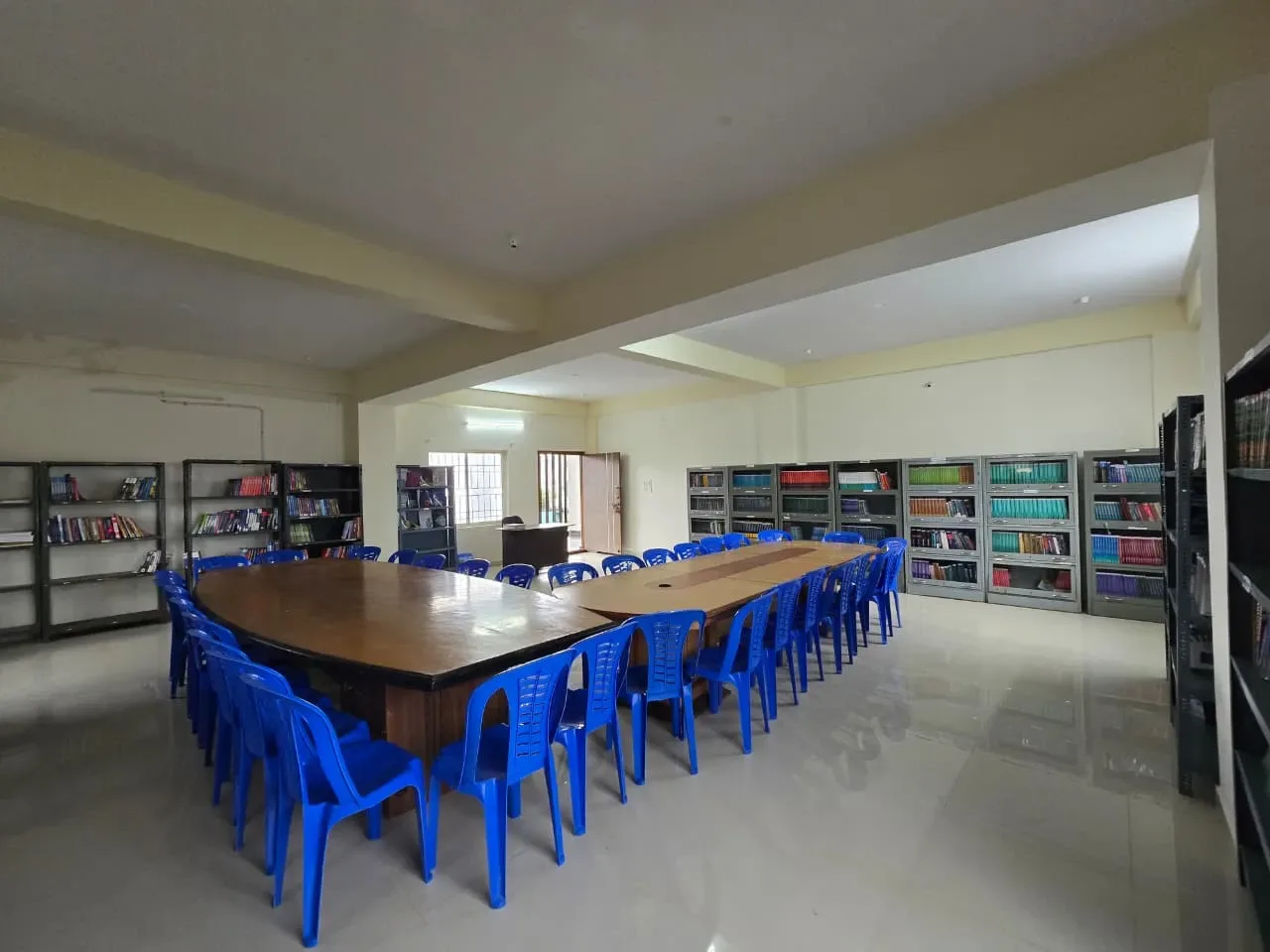 College library with reading tables and bookshelves — Shubham College of Nursing