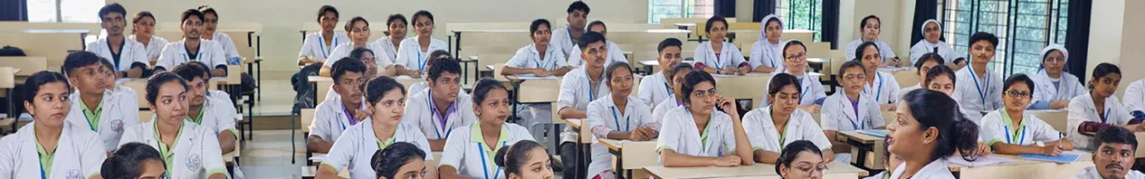 MBBS students in white coats attending a lecture at Father Muller Medical College, Mangalore