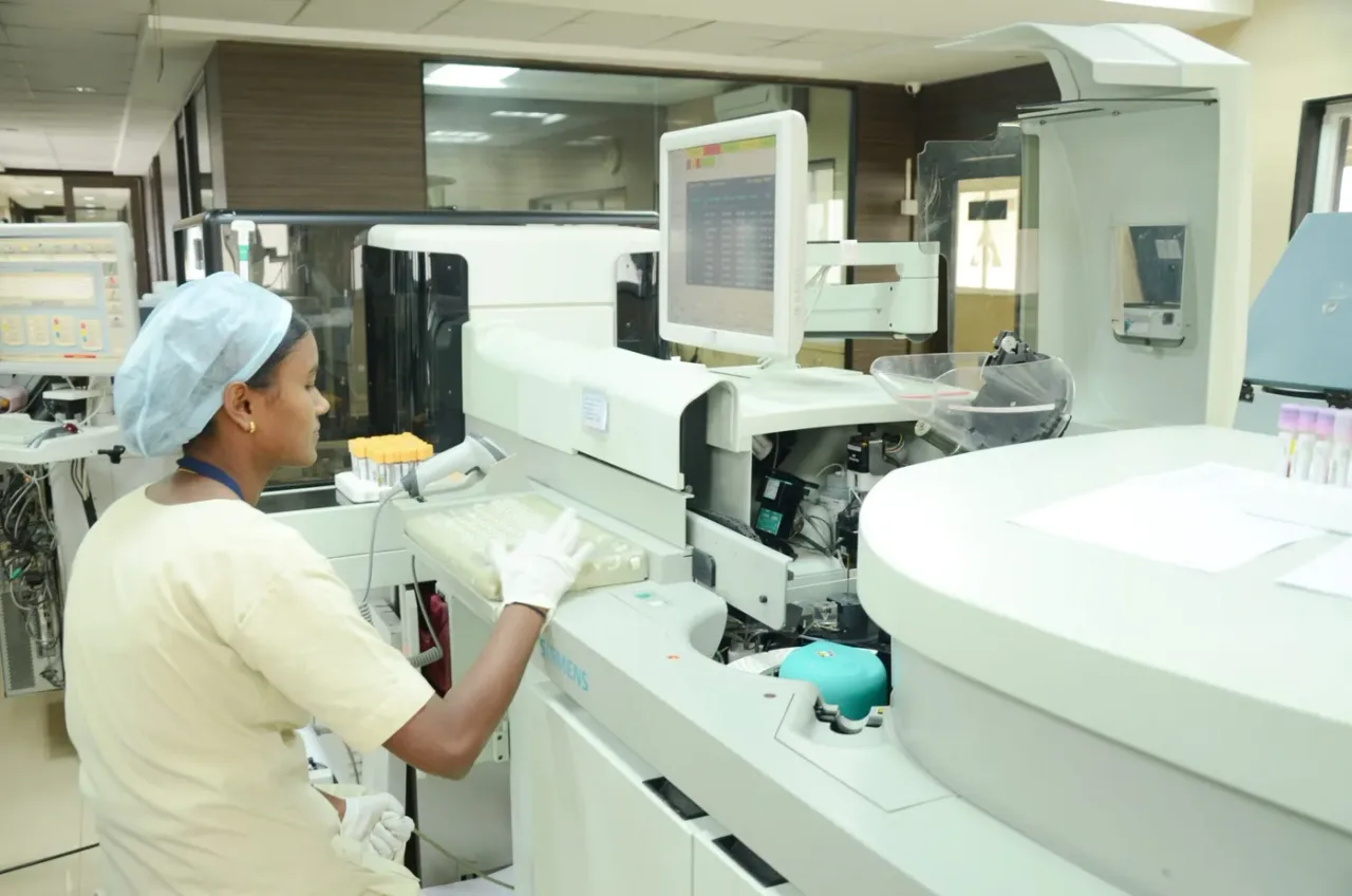 Lab technician operating an automated analyser in the hi-tech laboratory at Jawaharlal Nehru Medical College Belagavi