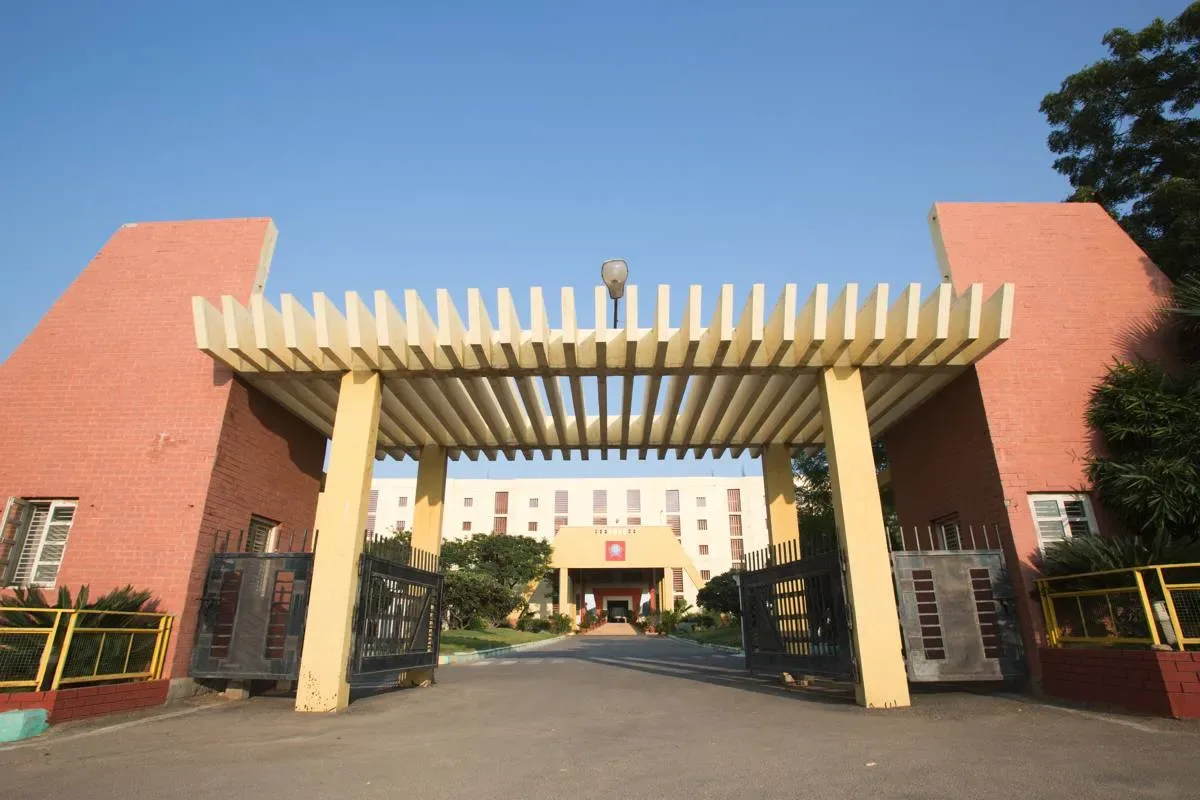 Entrance arch and gates of the Navodaya campus at Raichur with the college building behind