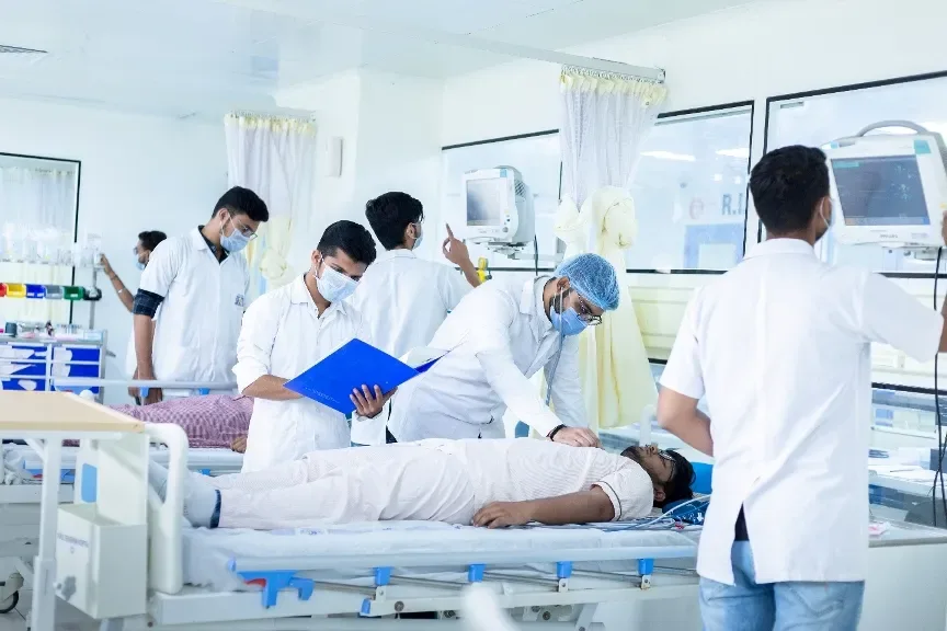 Nursing students receiving hands-on training around a patient bed — Parul Institute of Nursing