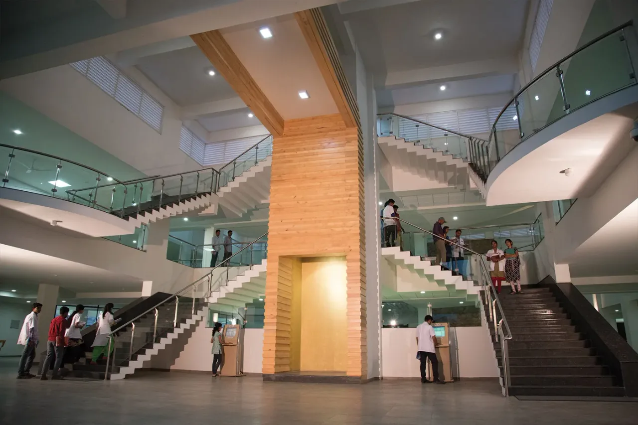 Multi-level atrium and staircases inside the Navodaya Medical College central library