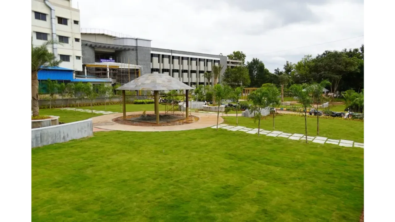 Landscaped lawn and gazebo in front of the Siddaganga Medical College building
