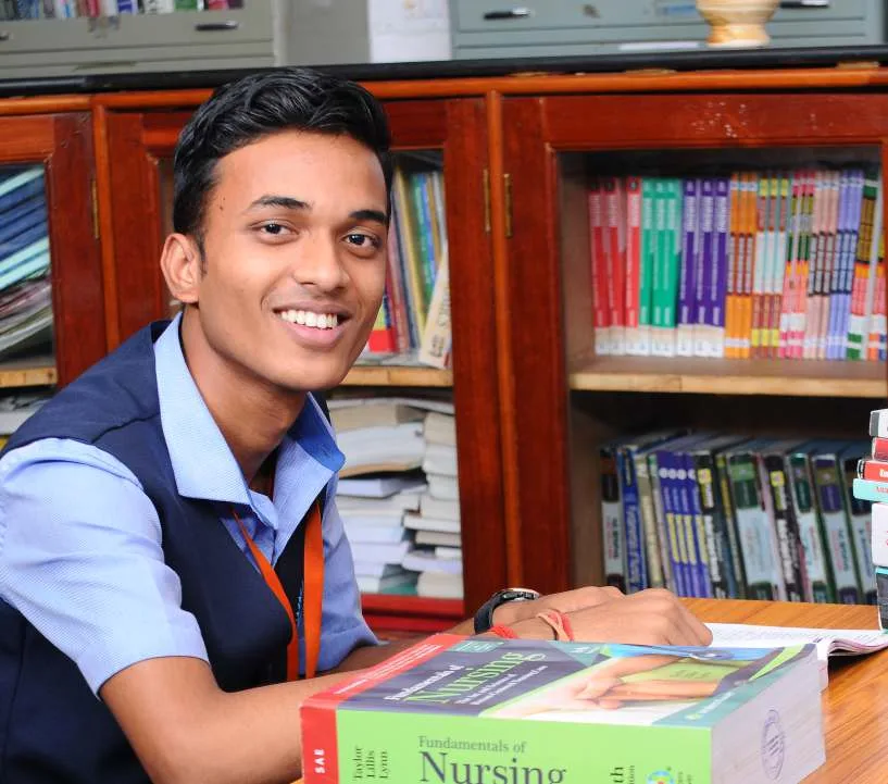 Mount Shepherd College of Nursing — Official Homepage Photo Gallery Image Student In Library With Nursing Textbook