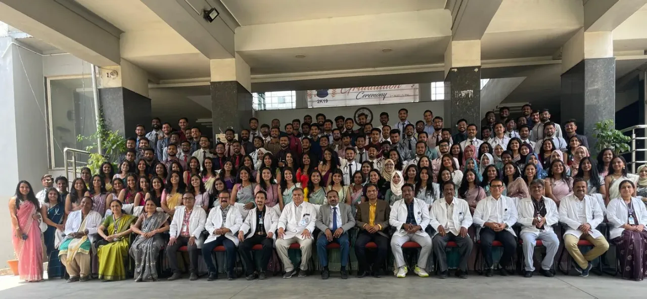 Graduating MBBS batch with faculty at the Mahadevappa Rampure Medical College graduation ceremony