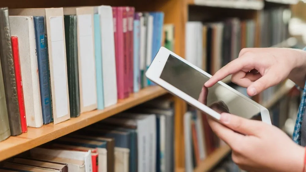 A student using a tablet to access medical journals in the campus digital library. — kalipalya-chanappa-institute-of-allied-health-sciences-nelamangala