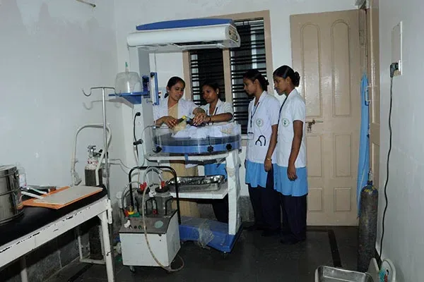 Nursing skills laboratory with students and clinical equipment — Vivekananda School & College of Nursing