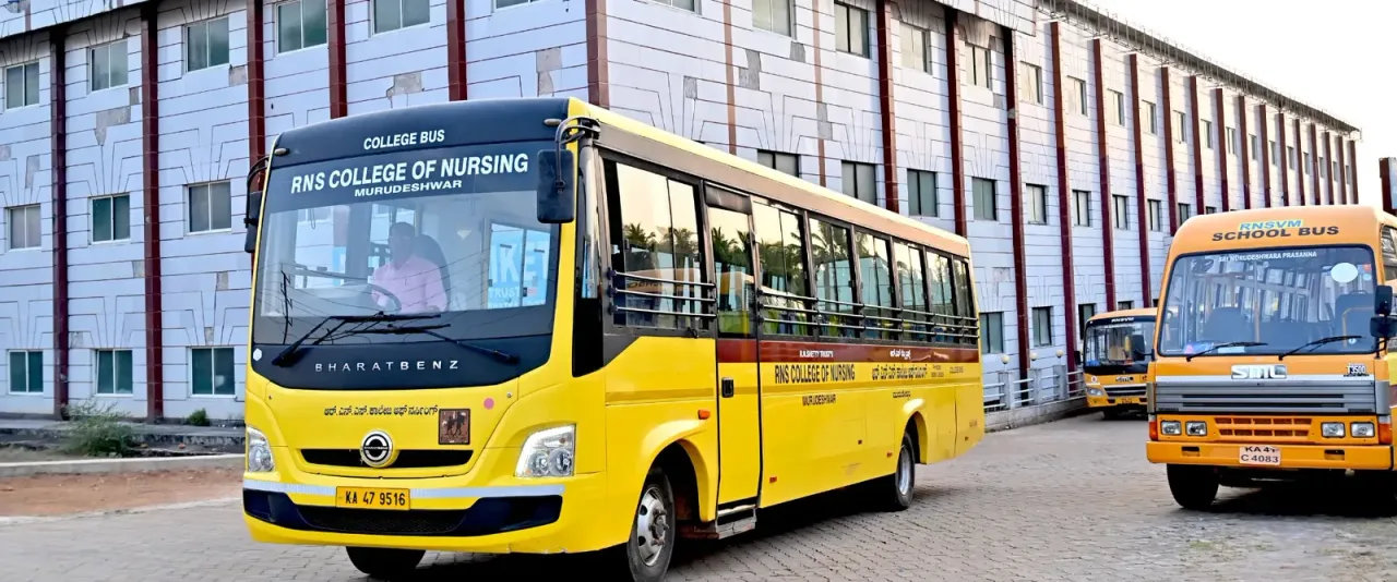 College buses parked beside the campus building — R.N.S. College of Nursing
