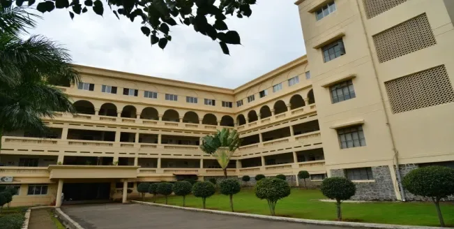 Courtyard view of the MIMER Medical College block with arched balconies, Talegaon Dabhade